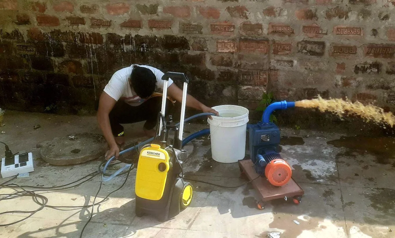 Technician preparing a rooftop water tank for cleaning