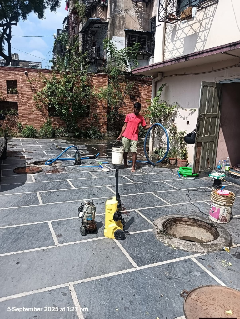 Team inspecting a water tank during cleaning
